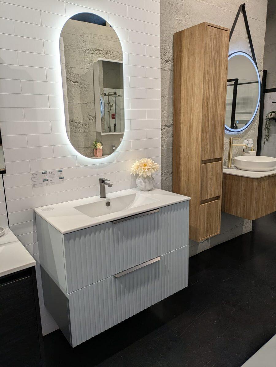 Fluted light blue vanity with an LED mirror