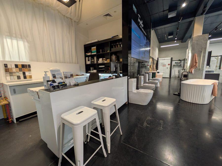 The showroom counter area, with toilet suites and a freestanding bath in view