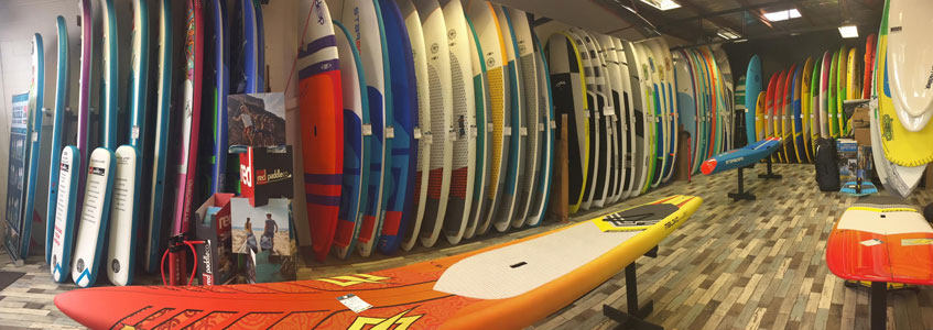 A shop full of Stand Up Paddle Boards.